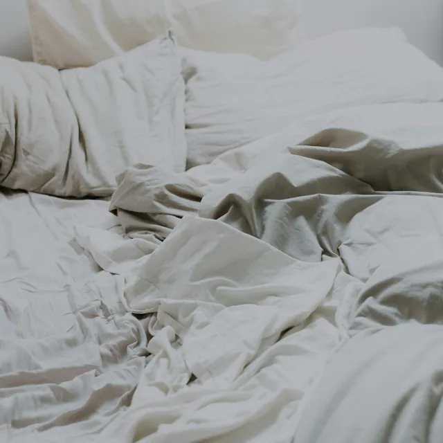White pillows and bedding on a bed